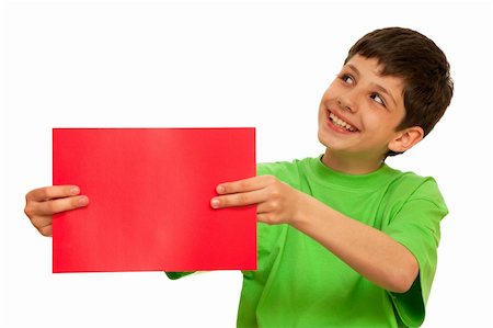 A smiling  boy is holding a sheet of red papper; isolated on the white background Stock Photo - Budget Royalty-Free & Subscription, Code: 400-04786454