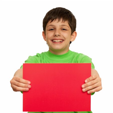 A boy is holding a sheet of red paper; isolated on the white background Stock Photo - Budget Royalty-Free & Subscription, Code: 400-04786453