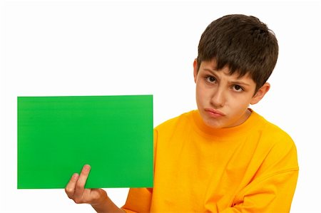 A sad boy is holding a sheet of green papper; isolated on the white background Stock Photo - Budget Royalty-Free & Subscription, Code: 400-04786460