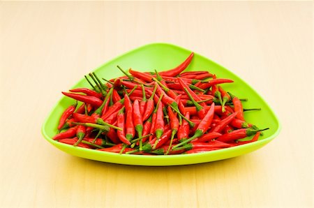 simsearch:400-04288181,k - Hot peppers in the plate on wooden table Photographie de stock - Aubaine LD & Abonnement, Code: 400-04786867