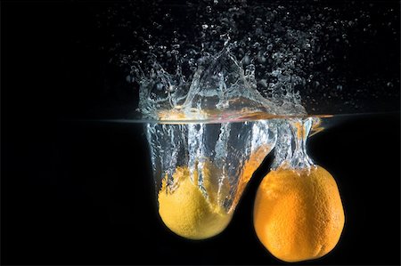 Fresh lemon dropped into water Stock Photo - Budget Royalty-Free & Subscription, Code: 400-04787380