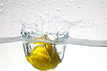 Fresh lemon dropped into water Stock Photo - Budget Royalty-Free & Subscription, Code: 400-04787382
