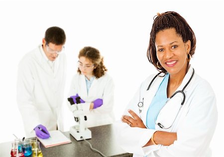 science laboratory black white - African-american female doctor with lab techs in background.  Isolated on white. Stock Photo - Budget Royalty-Free & Subscription, Code: 400-04787708