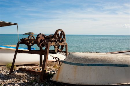 simsearch:400-04032663,k - Traditional fishing boats  ashore a beach amidst towing machinery Stock Photo - Budget Royalty-Free & Subscription, Code: 400-04787996