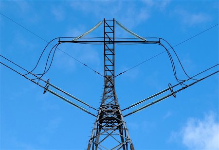 simsearch:400-04853699,k - Power lines and electric pylon against a blue cloudy sky. Photographie de stock - Aubaine LD & Abonnement, Code: 400-04788196
