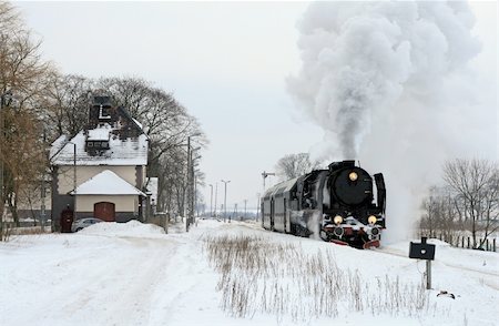 Old retro steam train starting from the station during wintertime Stock Photo - Budget Royalty-Free & Subscription, Code: 400-04788696