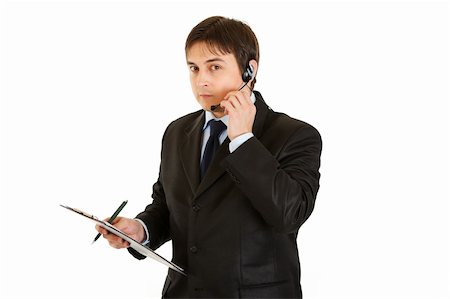 Serious young businessman with headset and clipboard isolated on white Stock Photo - Budget Royalty-Free & Subscription, Code: 400-04788980