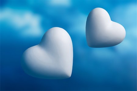 Two hearts against a out of focus blue sky background Stock Photo - Budget Royalty-Free & Subscription, Code: 400-04789565