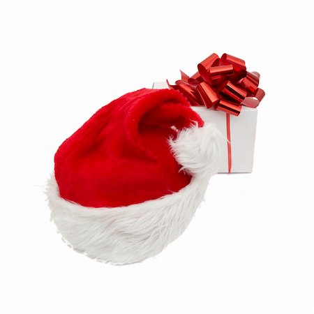 simsearch:400-05701397,k - Santa hat and giftisolated on white background Fotografie stock - Microstock e Abbonamento, Codice: 400-04780296