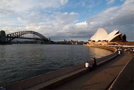 NSW, People waiting for an event to begin in front the Sydney Opera House on a cloudy day; view of Port Jackson with Sydney Harbour Bridge and the skyline in the background. Photographie de stock - Aubaine LD & Abonnement, Code: 400-04781534