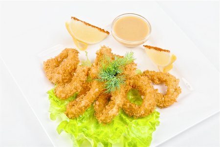 simsearch:400-08223319,k - Deep-fried squid with salad leaves, sauce, green and lemon on a white background Stock Photo - Budget Royalty-Free & Subscription, Code: 400-04781675