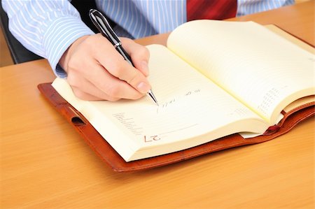simsearch:400-04782141,k - Businessman writing a note at his workplace. Stock Photo - Budget Royalty-Free & Subscription, Code: 400-04782141