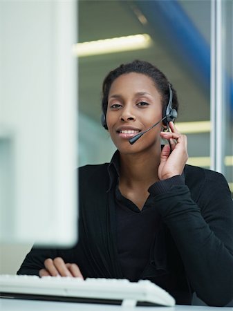 female african american customer service representative with headset looking at camera and smiling. Verical shape, front view, waist up Stock Photo - Budget Royalty-Free & Subscription, Code: 400-04782208
