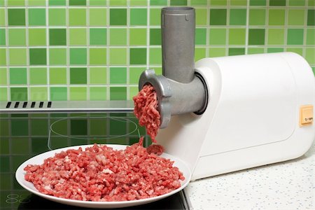 simsearch:400-06568412,k - Meat grinder on kitchen, mincemeat on background of the tiled bar Foto de stock - Super Valor sin royalties y Suscripción, Código: 400-04782363