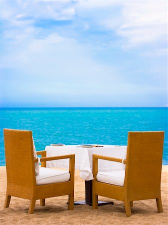 simsearch:851-02964112,k - Dining table on white sand beach close to the ocean Stock Photo - Budget Royalty-Free & Subscription, Code: 400-04782612