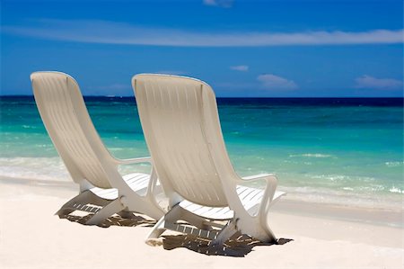 simsearch:841-02716786,k - Two beach chairs on a clean, sunny beach. Maldives Photographie de stock - Aubaine LD & Abonnement, Code: 400-04782629