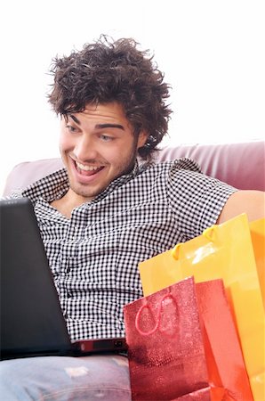 a young man  using his credit card to purchase over the internet, happiness and amazement Stock Photo - Budget Royalty-Free & Subscription, Code: 400-04783894