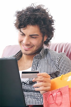 a young man  using his credit card to purchase over the internet, happiness and amazement Stock Photo - Budget Royalty-Free & Subscription, Code: 400-04783893