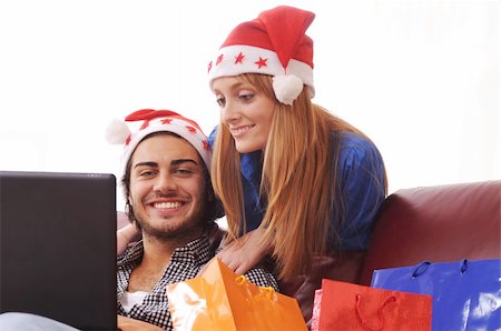 young couple using internet for christmas shopping Stock Photo - Budget Royalty-Free & Subscription, Code: 400-04783904