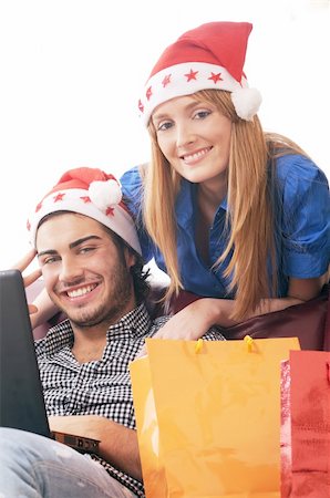 young couple in Christmas on-line shopping on white background Stock Photo - Budget Royalty-Free & Subscription, Code: 400-04783905