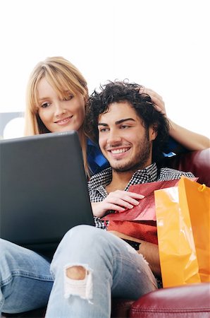 a young couple  using his credit card to purchase over the internet, happiness and amazement Stock Photo - Budget Royalty-Free & Subscription, Code: 400-04783903