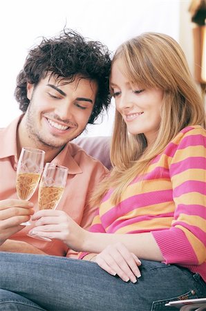 young couple smiling and drinking together Stock Photo - Budget Royalty-Free & Subscription, Code: 400-04783910