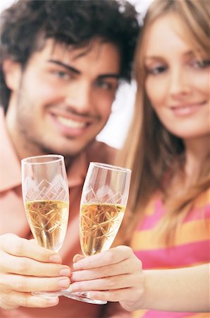 young couple smiling and drinking together Stock Photo - Budget Royalty-Free & Subscription, Code: 400-04783912