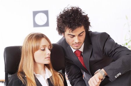 worker couple look the watch in the office Stock Photo - Budget Royalty-Free & Subscription, Code: 400-04783920