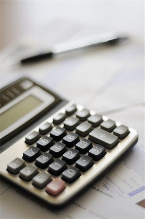 calculator and numbers with pen on the table Stock Photo - Budget Royalty-Free & Subscription, Code: 400-04783923