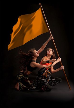 photos warriors long hair - Two young girl rising flag with paintball gun in their hands. File includes clipping path of flag. Stock Photo - Budget Royalty-Free & Subscription, Code: 400-04794517