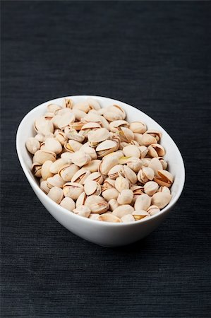 pistachio kernel - white bowl of pistachio on a black rag Stock Photo - Budget Royalty-Free & Subscription, Code: 400-04797620