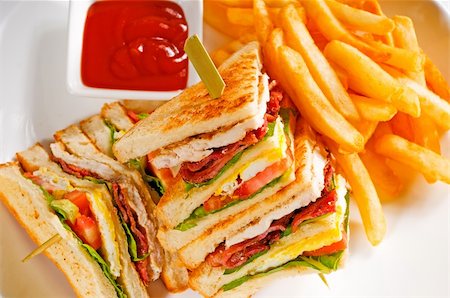 fresh triple decker club sandwich with french fries on side Stock Photo - Budget Royalty-Free & Subscription, Code: 400-04798472