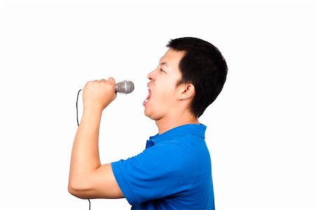 simsearch:400-05050679,k - Young man with a microphone singing Stock Photo - Budget Royalty-Free & Subscription, Code: 400-04798529