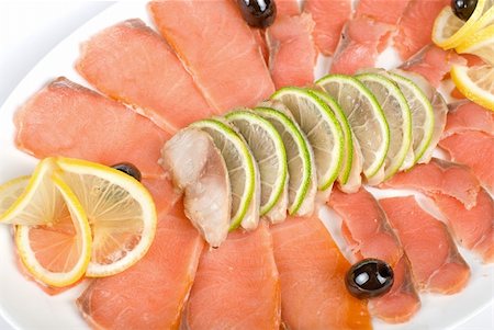 Sliced chum salmon and mackerel closeup decorated with limes, lemons and olives Photographie de stock - Aubaine LD & Abonnement, Code: 400-04799141