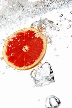 Fresh grapefruit dropped into water Stock Photo - Budget Royalty-Free & Subscription, Code: 400-04790950