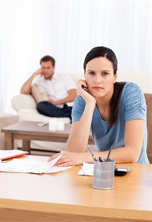 simsearch:400-05746763,k - Couple sulking after doing their account together in the living room Stock Photo - Budget Royalty-Free & Subscription, Code: 400-04791746