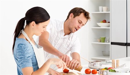 Man putting salt and pepper while his girlfriend stiring the sauce in the kitchen Stock Photo - Budget Royalty-Free & Subscription, Code: 400-04791755