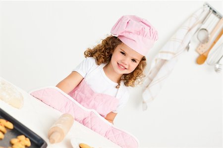rolling over - Portrait of a cute girl preparing cookies in the kitchen Stock Photo - Budget Royalty-Free & Subscription, Code: 400-04791769