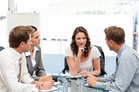 Charismatic businesswoman at a table with her team during a meeting Stock Photo - Budget Royalty-Free & Subscription, Code: 400-04791820