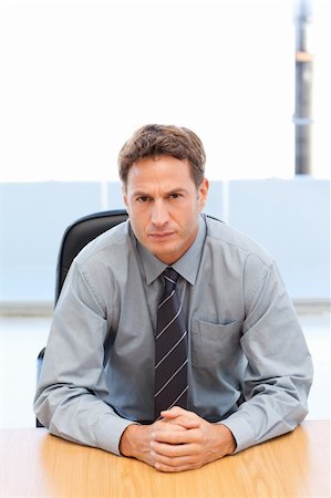 simsearch:400-04287211,k - Confident manager posing alone at a table in an office Stock Photo - Budget Royalty-Free & Subscription, Code: 400-04791951