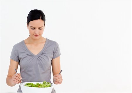 simsearch:400-04853599,k - Pretty woman preparing a salad with tomatoes in the kitchen at home Foto de stock - Royalty-Free Super Valor e Assinatura, Número: 400-04791969