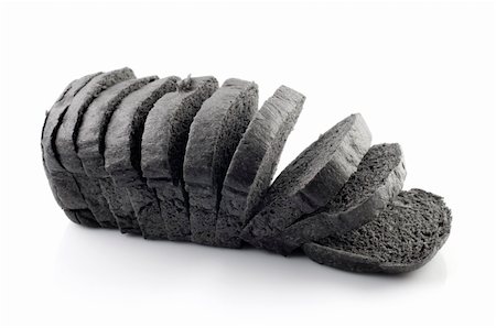 The cut loaf of black charcoal bread isolated on white Stock Photo - Budget Royalty-Free & Subscription, Code: 400-04792468