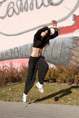 funky cartoon girls - young attractive woman in hip hop dress dancing and jumping near a graffiti wall Stock Photo - Budget Royalty-Free & Subscription, Code: 400-04792655