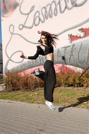 funky cartoon girls - young attractive woman in hip hop dress dancing and jumping in urban background Stock Photo - Budget Royalty-Free & Subscription, Code: 400-04792656
