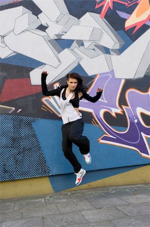 simsearch:400-04634435,k - young attractive woman in hip hop dress dancing and jumping in urban background Stock Photo - Budget Royalty-Free & Subscription, Code: 400-04792653