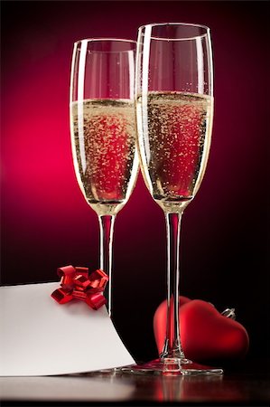 simsearch:400-04288408,k - Two full glasses of champagne over red background Stock Photo - Budget Royalty-Free & Subscription, Code: 400-04793136