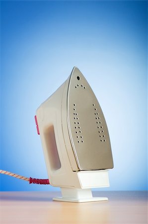simsearch:400-08427564,k - Modern electric iron against the colorful background Photographie de stock - Aubaine LD & Abonnement, Code: 400-04793624