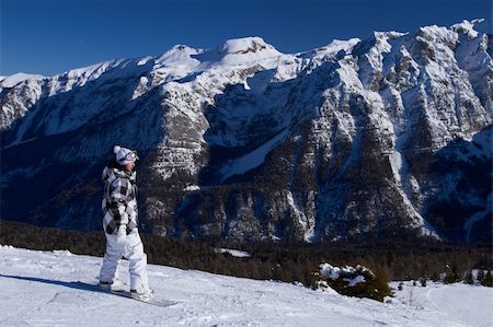 extreme cold clothes women - Female snowboarder is riding on snow in Dolomites Stock Photo - Budget Royalty-Free & Subscription, Code: 400-04793866