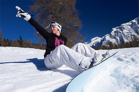 simsearch:400-04289173,k - Gorgeous female snowboarder pointing with her hand Stock Photo - Budget Royalty-Free & Subscription, Code: 400-04793869