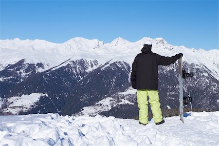 simsearch:400-04289173,k - Relaxed snowboarder is looking on high mountains Stock Photo - Budget Royalty-Free & Subscription, Code: 400-04793862